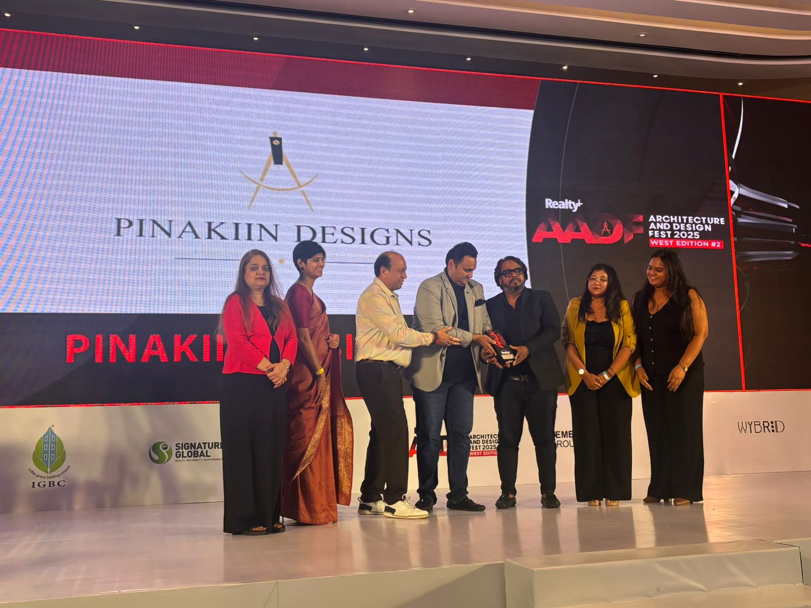 The Pinakiin Designs team collecting the Realty+ award
